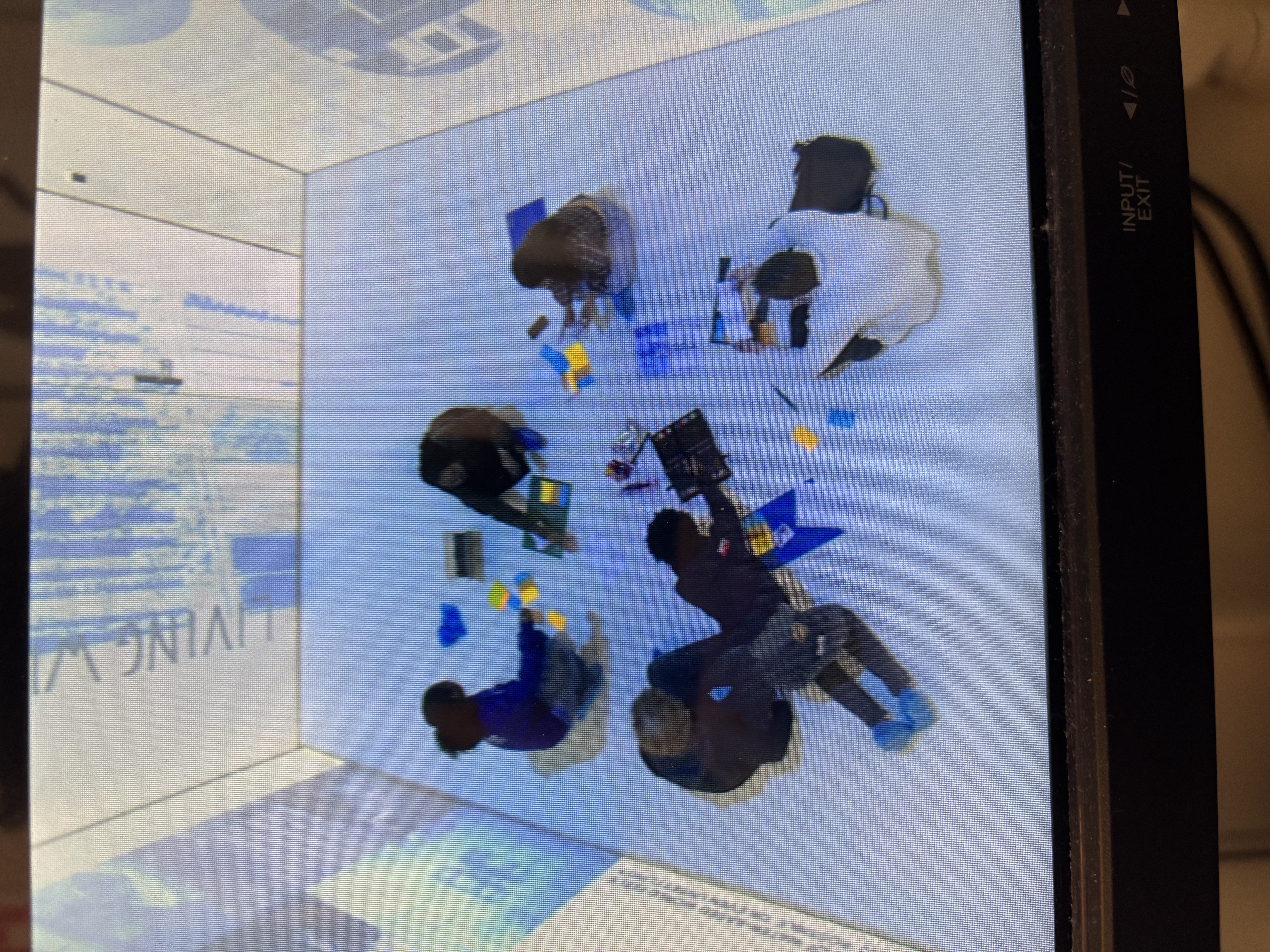 A picture of a birds eye view of a participatory worshop in an Immersive Environment room.